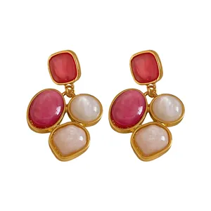 Elegant irregular geometric resin petal stud earrings with silver needles in gold tone.