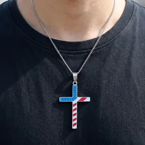 Detailed view of a stainless steel USA flag cross pendant necklace on a male model