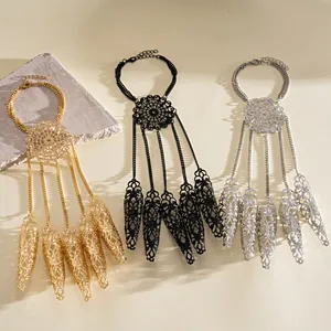 Detailed view of exaggerated hollow filigree hand harness with five finger sleeve caps set
