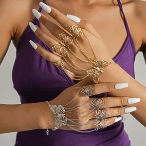 Detailed macro view of gold and silver butterfly slave bracelets with hollow rings.