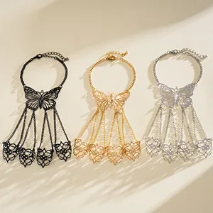 Detailed view of three butterfly slave bracelets in black, gold, and silver finishes.