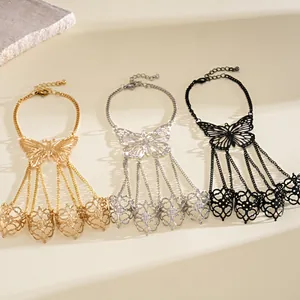 Detail of three butterfly slave bracelets in gold, silver, and black hollow designs