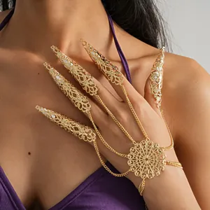 Intricate gold filigree claw rings and floral hand chain bracelet jewelry detail