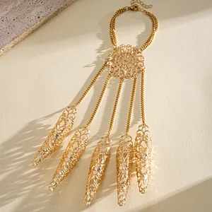Detailed macro view of a gold hollow finger sleeve bracelet featuring filigree design