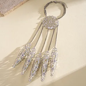 Detailed close-up of hollowed-out filigree silver finger harness bracelet with mandala motif