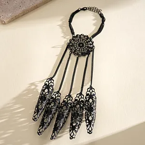 Detailed shot of black gothic filigree hand chain with claw finger sleeves
