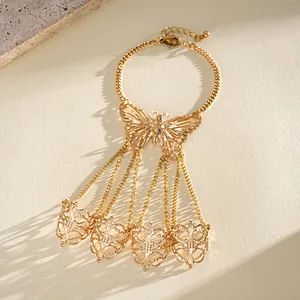 Detail view of gold butterfly slave bracelet with hollowed finger rings and chains