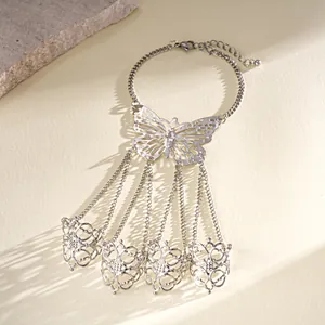 Detailed view of a silver hollow butterfly slave bracelet with intricate filigree rings