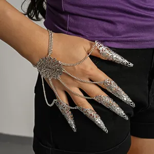 Detailed view of a silver filigree finger claw bracelet with ornate chain connectors.