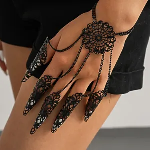 Detailed macro view of black hollow-out finger cuff bracelet with intricate lace filigree