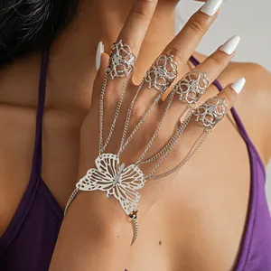 Detailed close-up view of silver hollow butterfly hand chain with four finger rings