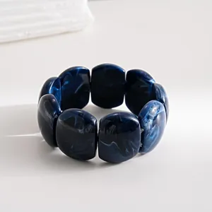 Close-up of a vintage dark blue marbled acrylic rectangular block stretch bracelet