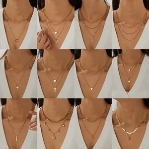 Multiple styles of layered gold plated stainless steel necklaces with heart pendants