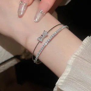 Detailansicht des eleganten silbernen Doppelarmbands mit Schleife und Pavé-Zirkonia-Steinen.