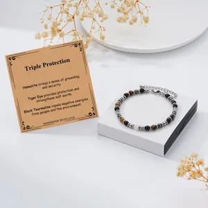 Detail showing the triple protection bracelet beads and the stone meaning card