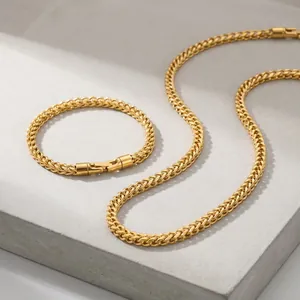 Close-up of 5mm stainless steel wheat chain necklace and bracelet set in gold