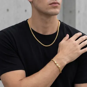 Detailed shot of a man wearing a 5mm gold stainless steel Franco chain necklace and bracelet