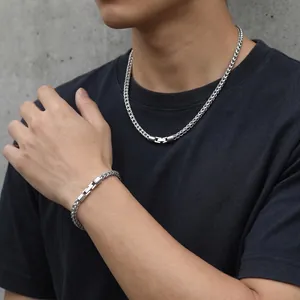 Detail of 5mm stainless steel wheat chain necklace and bracelet set on male model