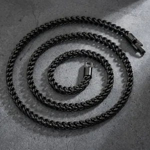Professional close-up of a 5mm black stainless steel wheat chain necklace on stone