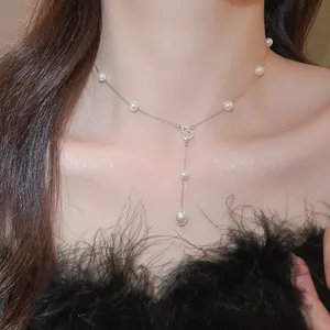 Elegant French style pearl necklace with a sparkling crystal heart pendant worn on neck