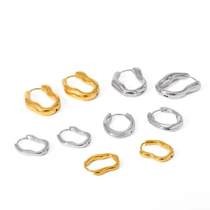 Detailed view of wavy stainless steel hoop earrings in gold and silver finish