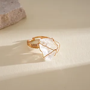 Detailed macro view of a handmade wire-wrapped ring with natural clear crystal quartz stone