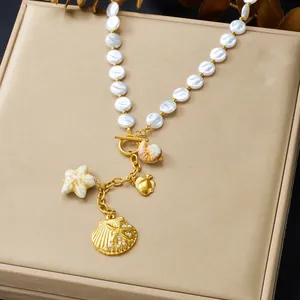 Close-up detail of summer pearl necklace featuring gold sea shell and starfish charms