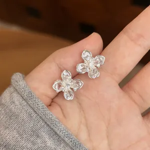 Elegant silver four-leaf flower stud earrings with sparkling clear zircon stones for women.