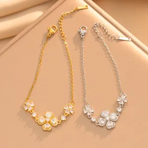 Détail de bracelets dorés et argentés avec des pétales de fleurs en zircons en cœur.