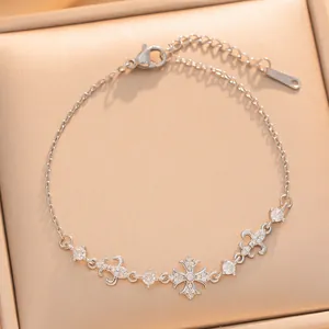 Detail view of dainty silver plated bracelet with sparkling zirconia flower charm.