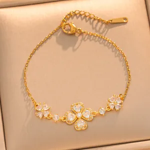 Vue détaillée des breloques florales scintillantes et de la chaîne de ce bracelet en or.