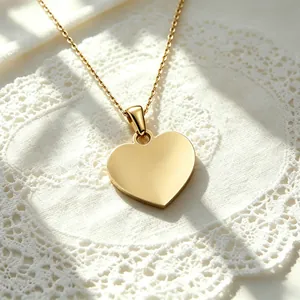 Detailed macro view of a polished gold heart pendant on a delicate chain
