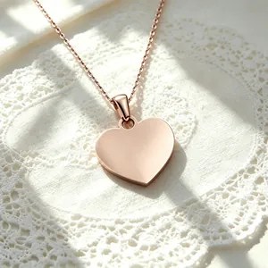 Detailed view of a polished rose gold stainless steel heart pendant necklace for DIY engraving.