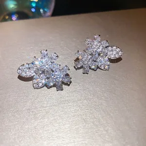 Exquisite silver needle stud earrings featuring sparkling zircon flower and leaf design motifs