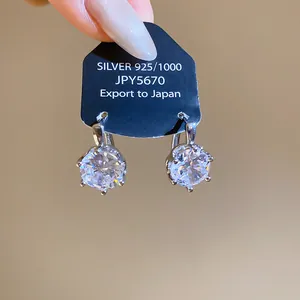 Detailed view of sterling silver stud earrings with sparkling cubic zirconia