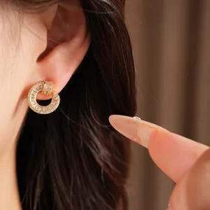 Close-up of elegant 18k gold plated round stud earrings featuring sparkling cubic zircons