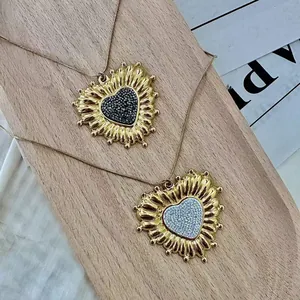 Two vintage gold-tone necklaces featuring heart-shaped zircon pendants with sunflower edges