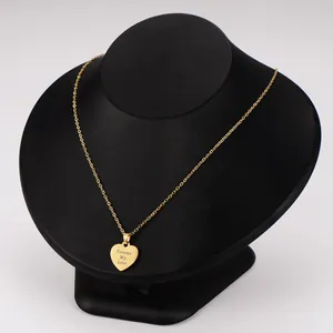 Detailed view of heart pendant necklace with Forever My Love engraving on display stand