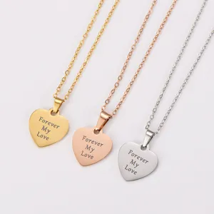 Detail view of three heart necklaces in gold, rose gold, and silver with love engraving.