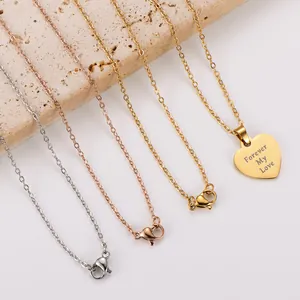 Detailed shot of engraved Forever My Love heart necklaces in gold, silver, rose gold