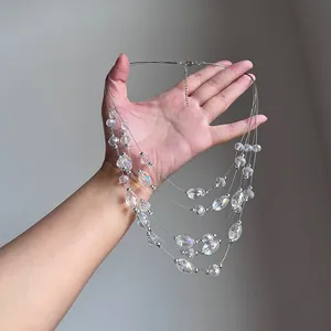 Close-up of multi-layer crystal beaded necklace with iridescent oval beads in hand
