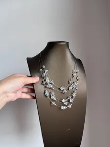 Detail view of a multi-strand crystal beaded necklace on a display bust