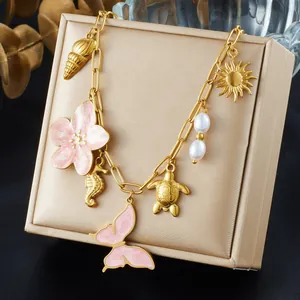 Exquisite gold plated ocean theme charm necklace featuring pink butterfly and sea turtle