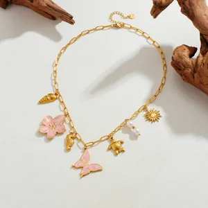 Detail of ocean series gold charm necklace with butterfly and sea turtle charms