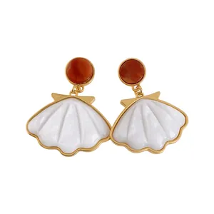 Vintage-inspired gold-toned shell resin dangle earrings in elegant white and red.