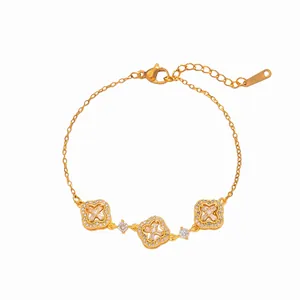 Elegant gold-tone chain bracelet featuring three sparkling zircon-encrusted clover charms