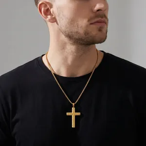 Detailed view of a vintage stainless steel twisted cross necklace on a male model.