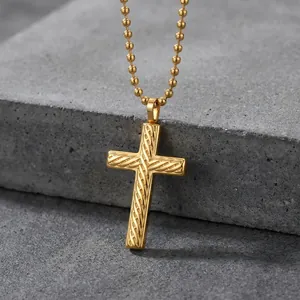 Gold stainless steel twisted cross pendant necklace with round ball chain on grey stone