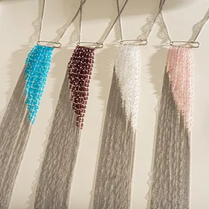 Close-up of four colorful beaded long tassel necklaces with metal chains