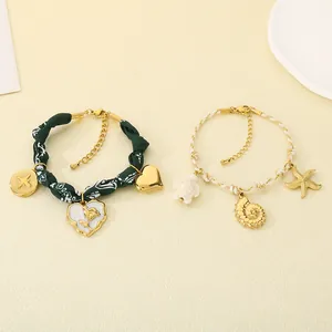 Close-up of summer ocean-themed bracelets with starfish, turtle and floral fabric details.